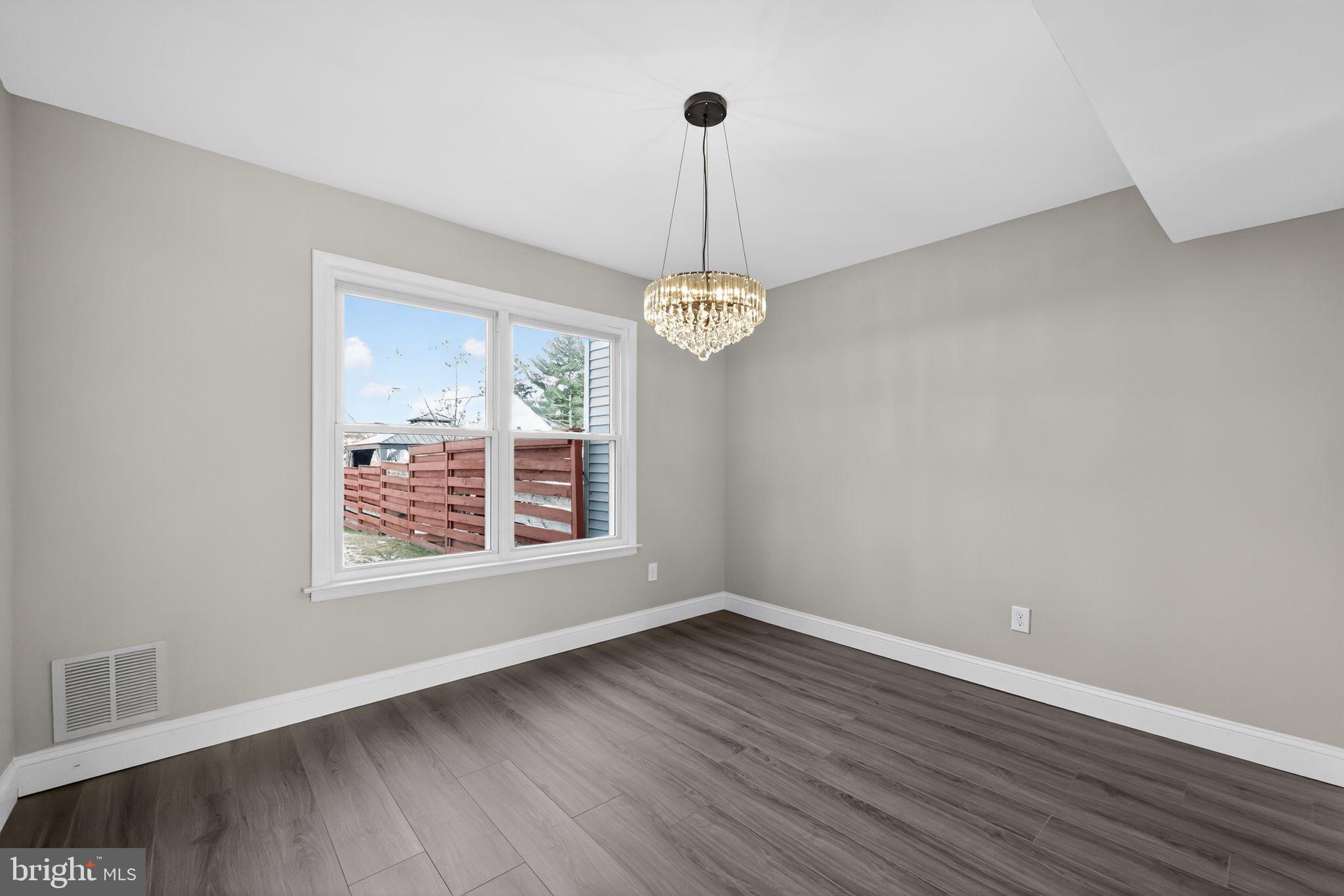 55 Adams Street Swedesboro, NJ 08085 - Photo 13 of 30 a view of an empty room with wooden floor and a window