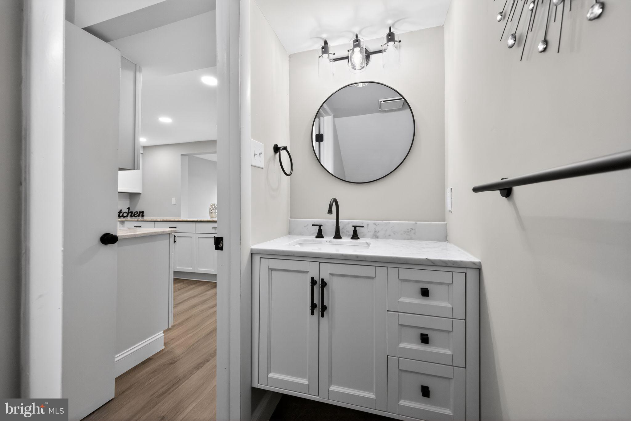 55 Adams Street Swedesboro, NJ 08085 - Photo 14 of 30 a bathroom with a sink mirror and vanity