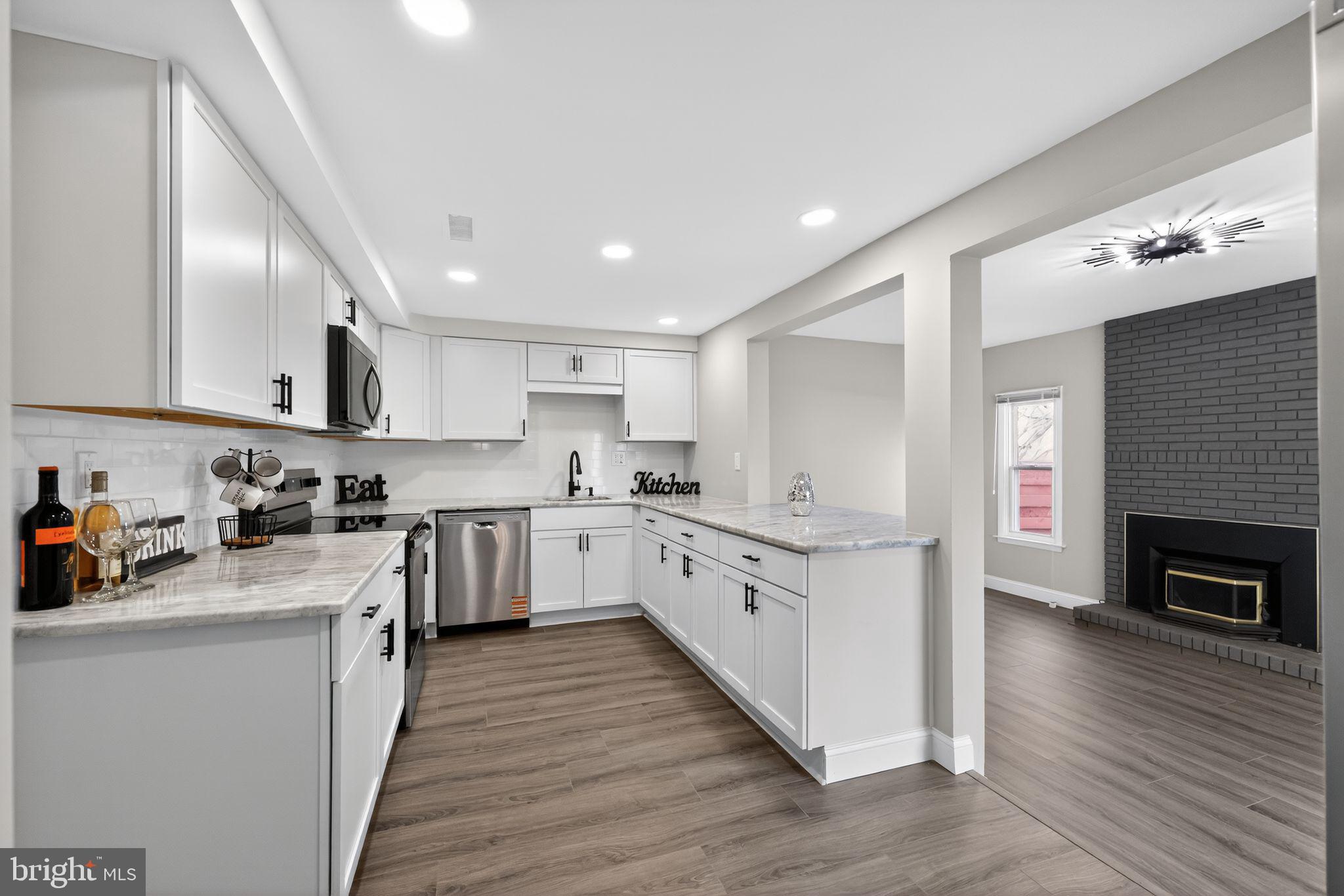 55 Adams Street Swedesboro, NJ 08085 - Photo 6 of 30 a kitchen with granite countertop a sink cabinets stainless steel appliances and wooden floor