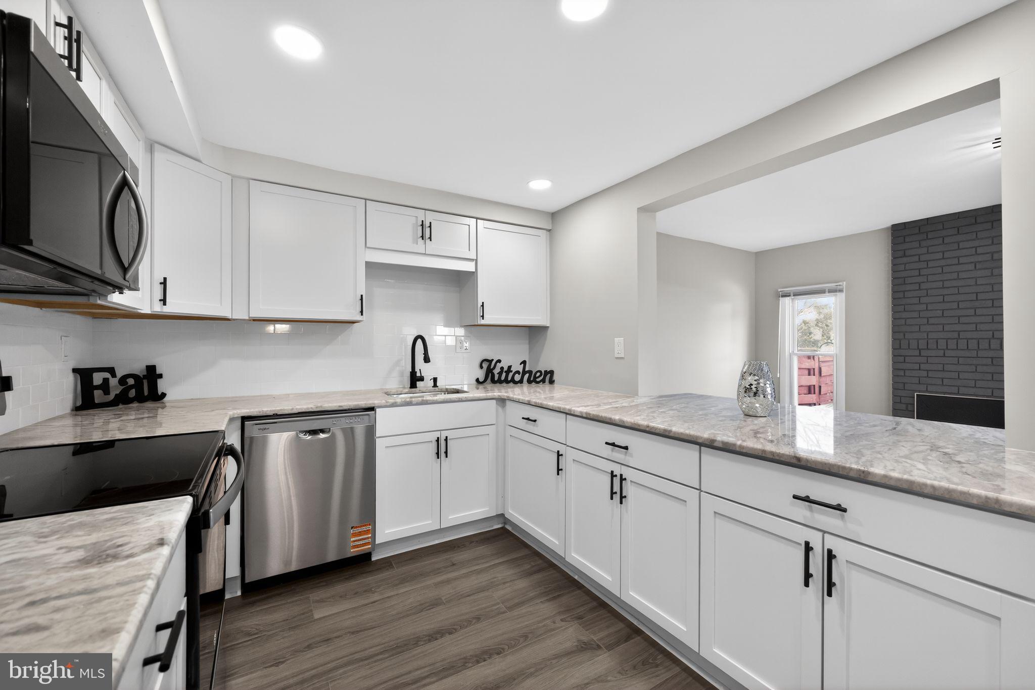 55 Adams Street Swedesboro, NJ 08085 - Photo 8 of 30 a kitchen with granite countertop cabinets stainless steel appliances a sink and a window