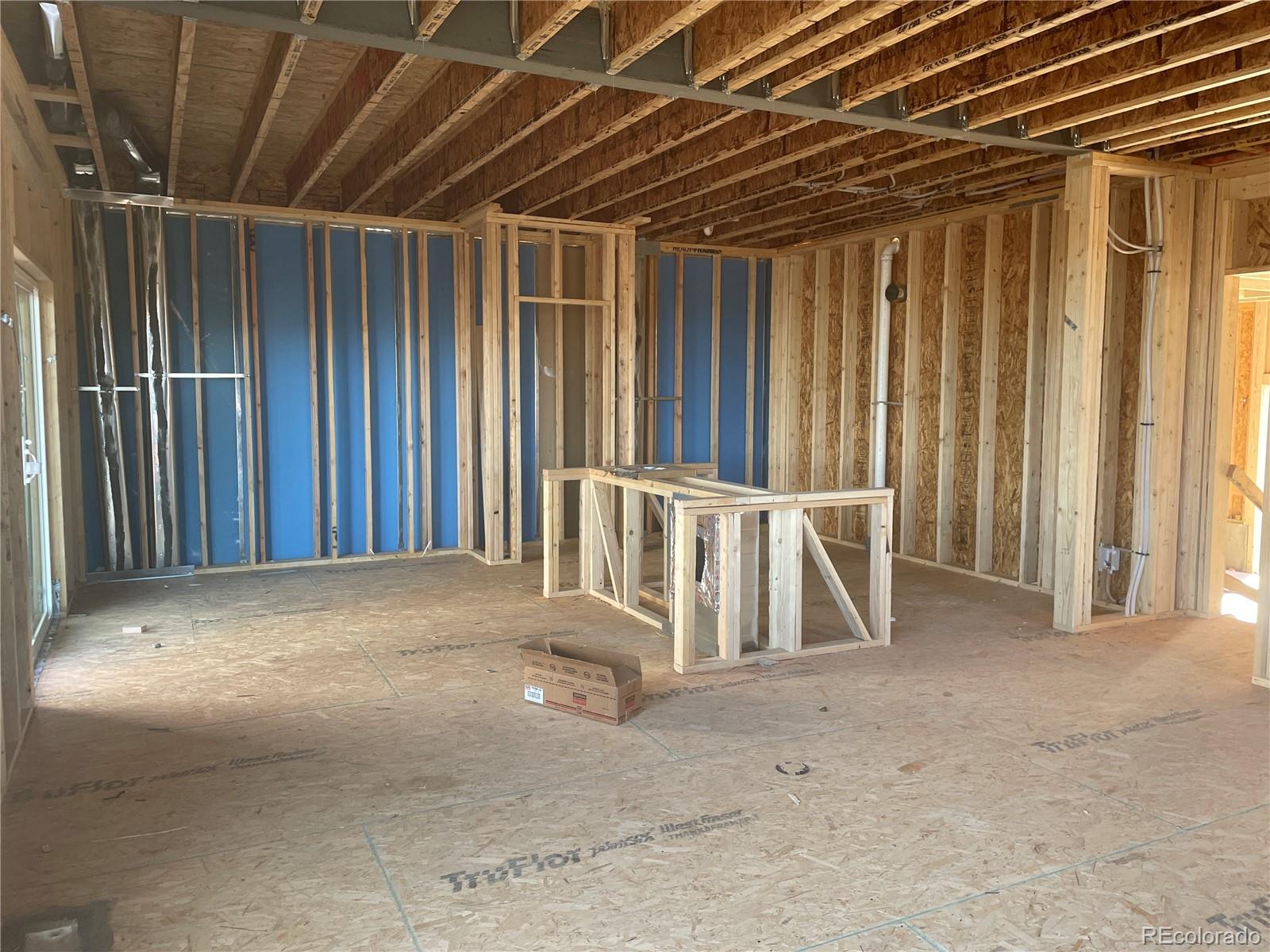 701 Eldorado Drive Erie, CO 80026 - Photo 2 of 10 a view of an empty room with wooden walls