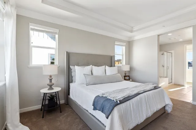 a bedroom with a bed lamp and a window