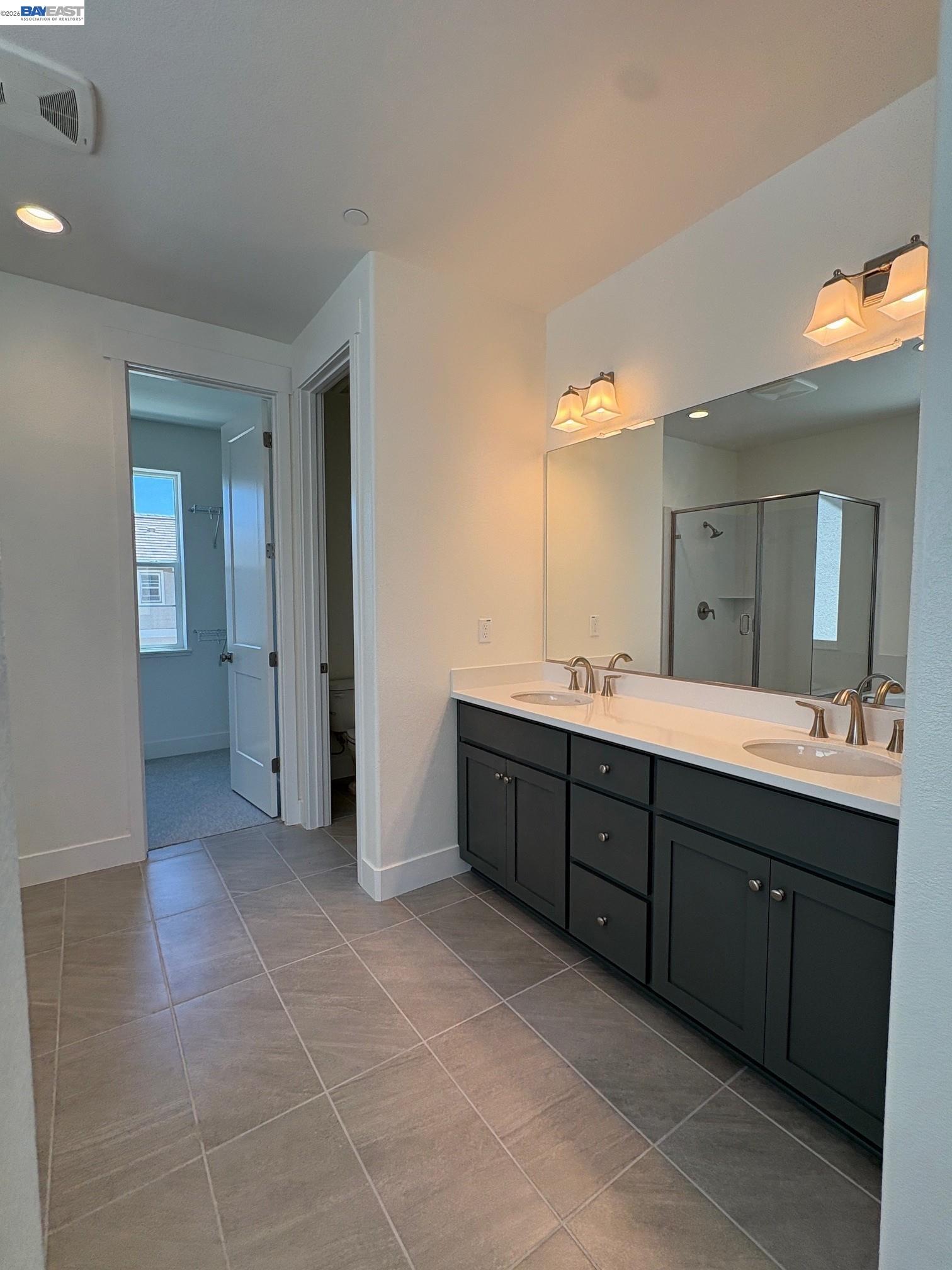 1476 Monument Lane Fairfield, CA 94533 - Photo 21 of 24 a spacious bathroom with a vanity a sink a mirror and a bathtub