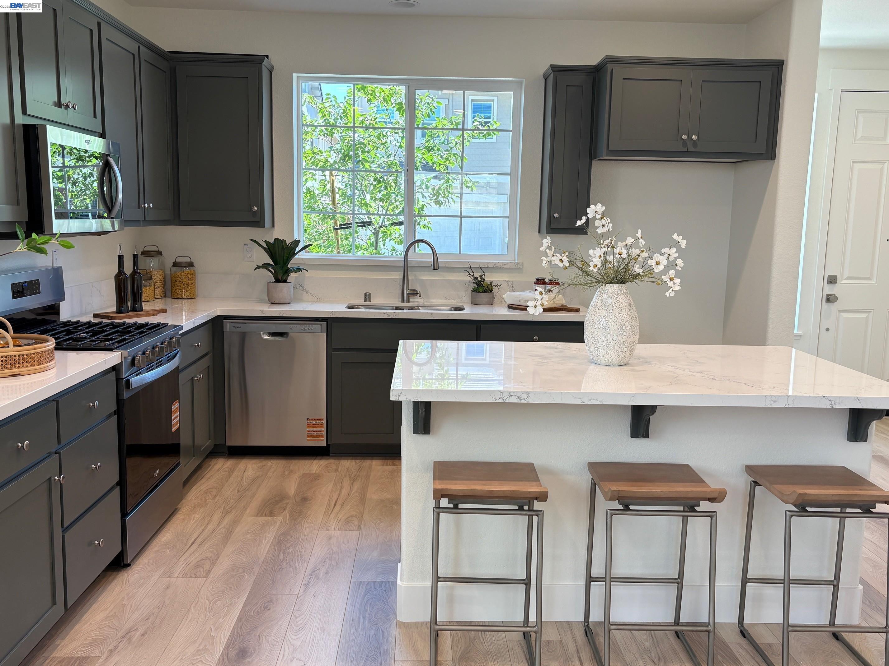 1476 Monument Lane Fairfield, CA 94533 - Photo 5 of 24 a kitchen with cabinets a sink dining table and chairs