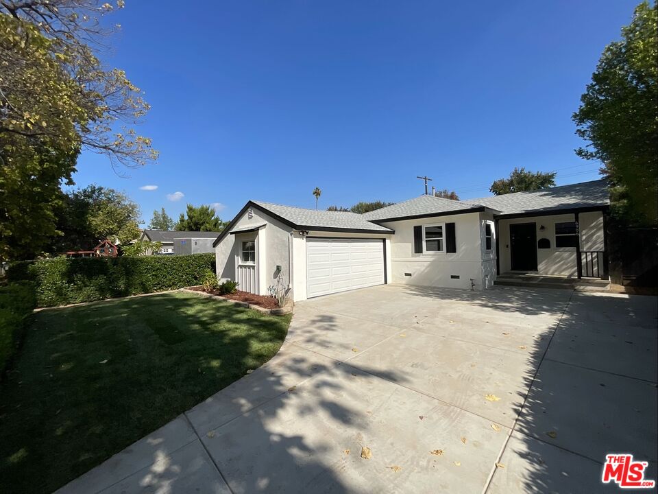 6906 Balcom Avenue Reseda, CA 91335 - Photo 1 of 19 a front view of a house with a garden and yard