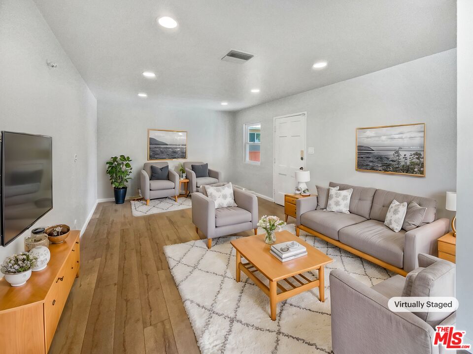 6906 Balcom Avenue Reseda, CA 91335 - Photo 2 of 19 a living room with furniture and a flat screen tv