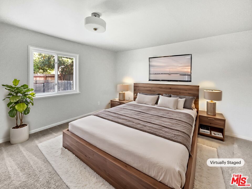 6906 Balcom Avenue Reseda, CA 91335 - Photo 4 of 19 a bedroom with a bed and a potted plant