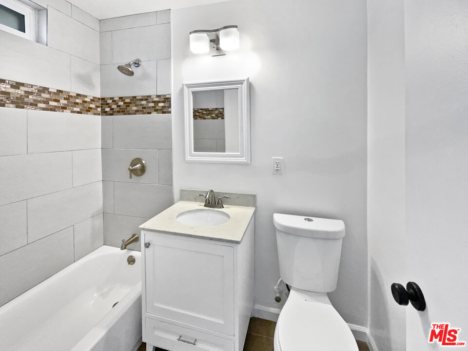 6906 Balcom Avenue Reseda, CA 91335 - Photo 7 of 19 a bathroom with a sink a toilet and shower