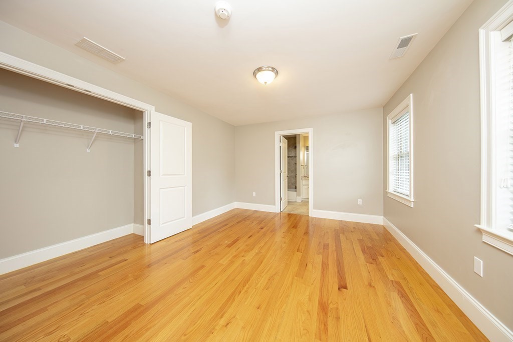 33 Liberty Avenue Lexington, MA 02420 - Photo 22 of 30 a view of an empty room with wooden floor and a window