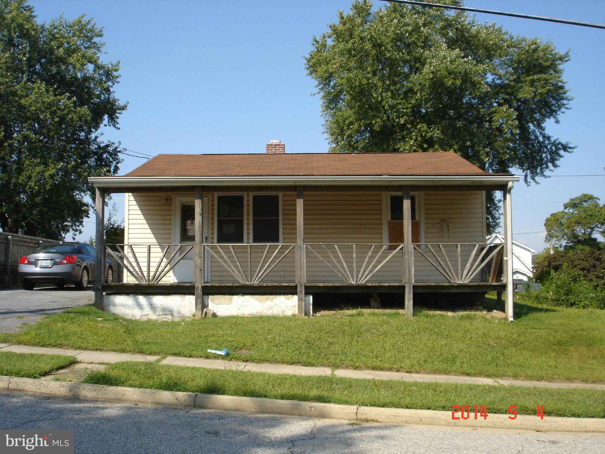 1828 Marshall Road Dundalk, MD 21222 - Photo 1 of 5 a front view of a house with a garden and plants