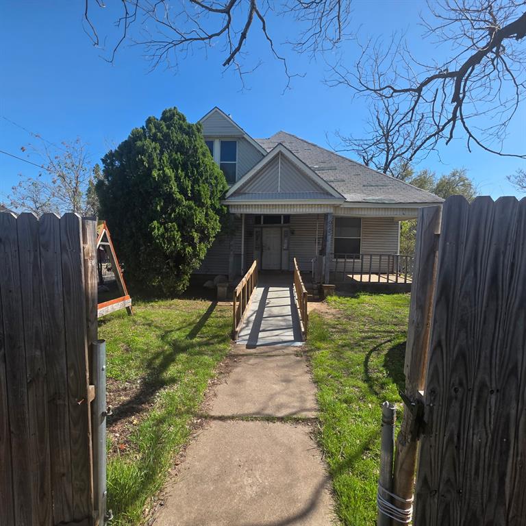 925 North 16th Street Waco, TX 76707 - Photo 1 of 6 a view of a pathway of a house with a small yard plants and large tree