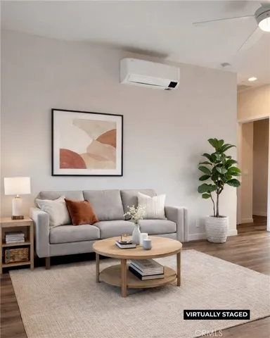 a living room with furniture and a potted plant