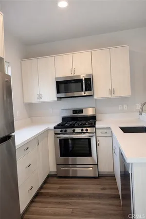 a kitchen with cabinets appliances and a sink