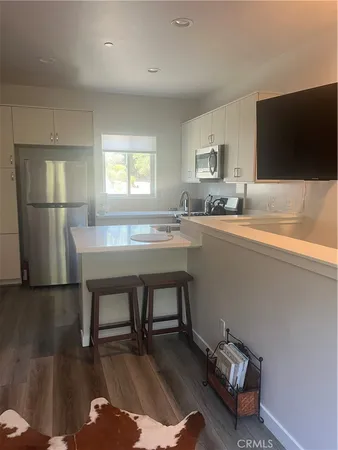 a kitchen with a sink appliances and a counter top space