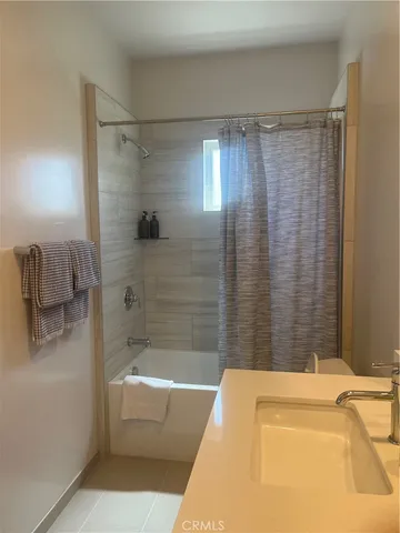 a bathroom with a bathtub and shower