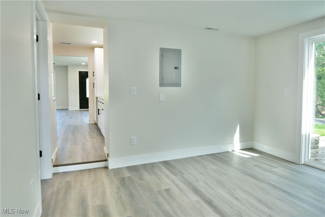 2096 Stillwagon Road Southeast Warren, OH 44484 - Photo 17 of 50 Unfurnished room with light wood-style floors, baseboards, and electric panel