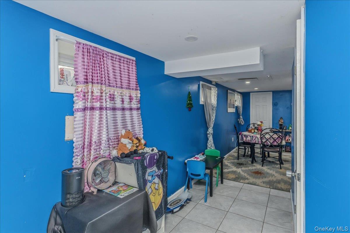 237 Rhodes Avenue Hempstead, NY 11550 - Photo 19 of 24 a dining room with furniture and a chandelier