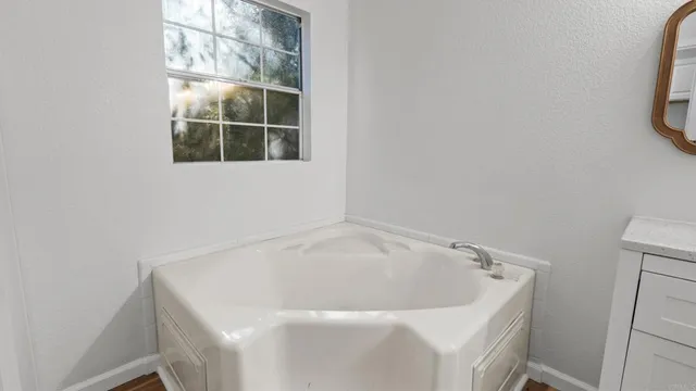 a bathroom with a bathtub and window