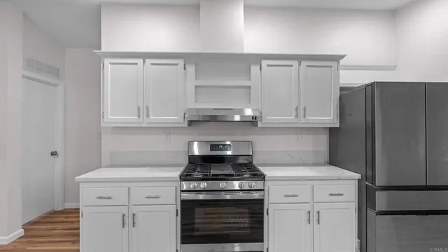a stove top oven sitting inside of a kitchen