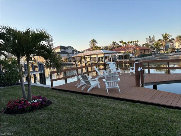 a view of a house with a yard and sitting area