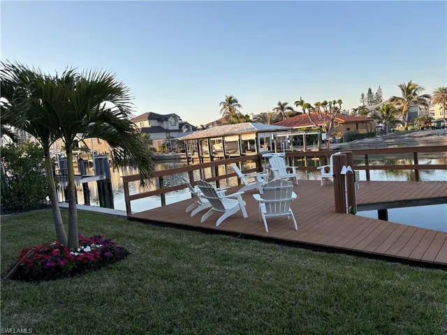 a view of a house with a yard and sitting area