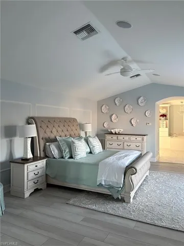 a living room with a bed furniture and kitchen view