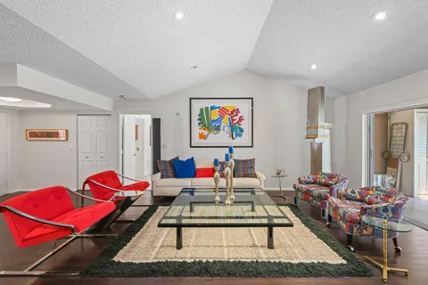 a living room with furniture rug and window