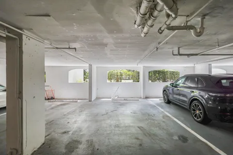 a view of a garage with a bike and cars