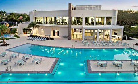 an aerial view of house with yard swimming pool and outdoor seating