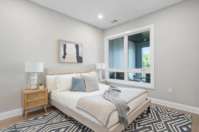 a bedroom with a bed and a night stand