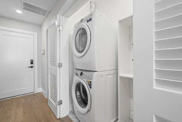 a view of a hallway with washer and dryer