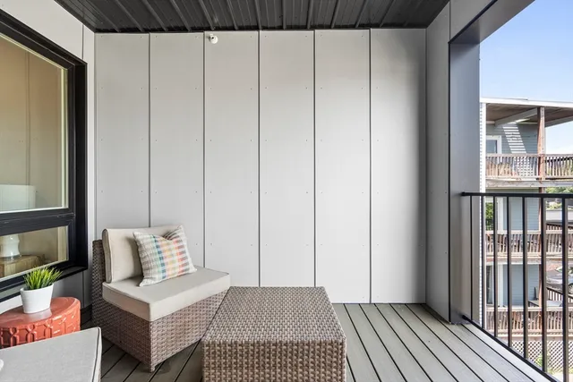 a view of a bedroom with furniture and wooden floor