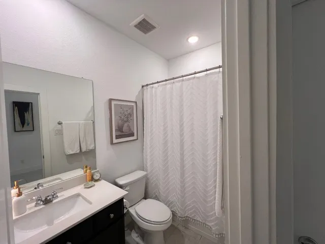 a living room with furniture chandelier and a large window
