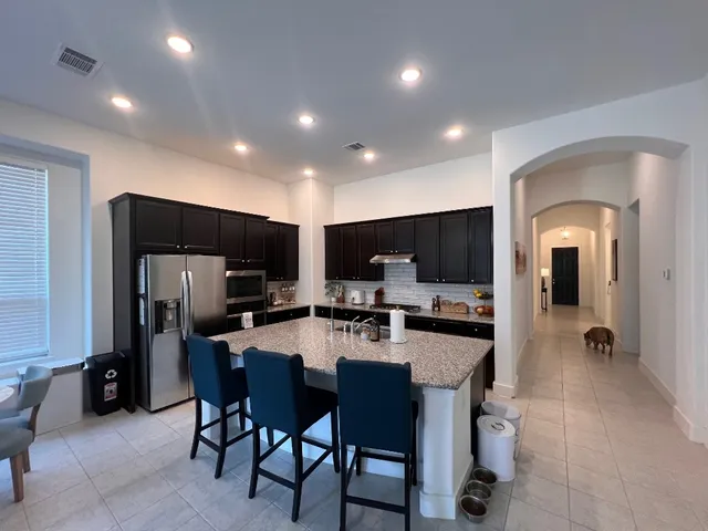 a living room with furniture fireplace and a large window
