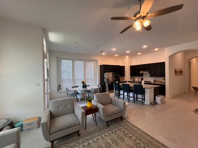 a view of a workspace with furniture and a window
