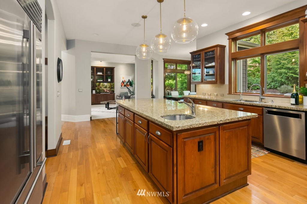 2989 Northeast Davis Loop Issaquah, WA 98029 - Photo 16 of 37 a kitchen with stainless steel appliances granite countertop a sink and a wooden floor