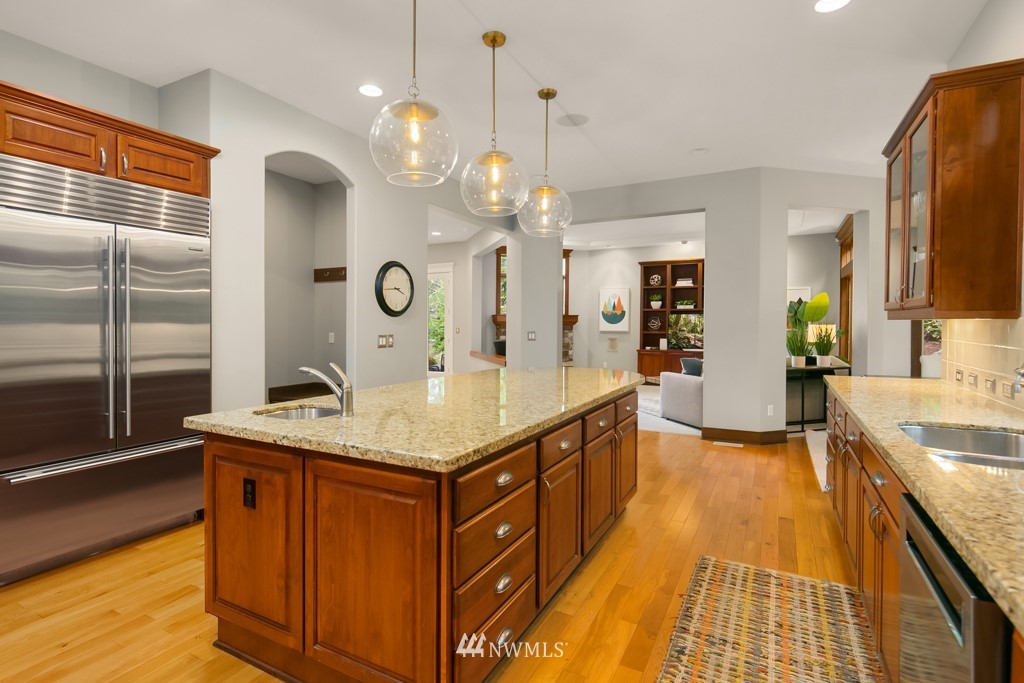 2989 Northeast Davis Loop Issaquah, WA 98029 - Photo 17 of 37 a spacious kitchen with stainless steel appliances granite countertop a sink and a wooden floor