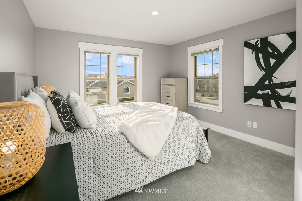 2989 Northeast Davis Loop Issaquah, WA 98029 - Photo 28 of 37 a bedroom with a bed a dresser and next to a window
