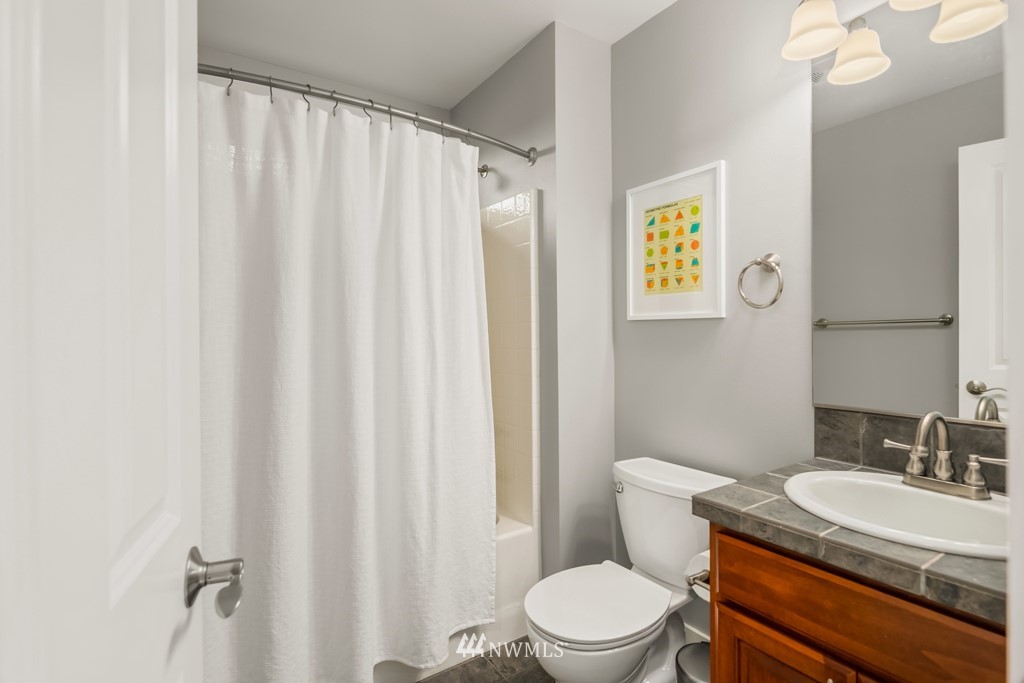 2989 Northeast Davis Loop Issaquah, WA 98029 - Photo 29 of 37 a bathroom with a granite countertop sink toilet and a mirror