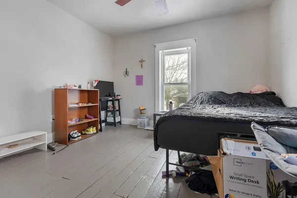 a bedroom with a bed and a window