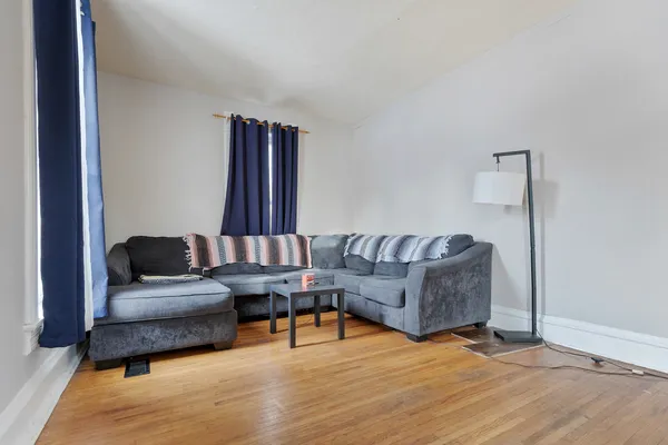 a living room with furniture and wooden floor