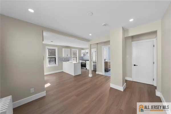 a view of a kitchen with wooden floor and a refrigerator