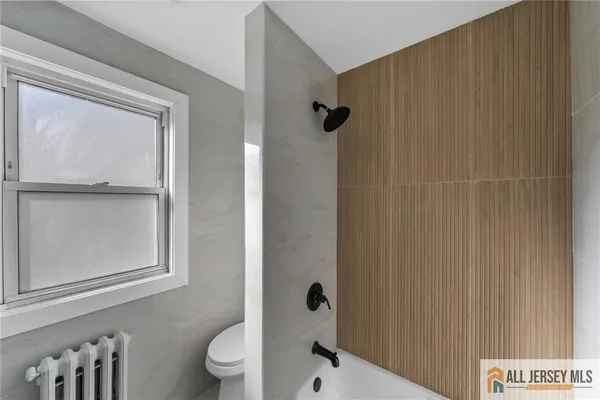 a bathroom with a shower and a toilet
