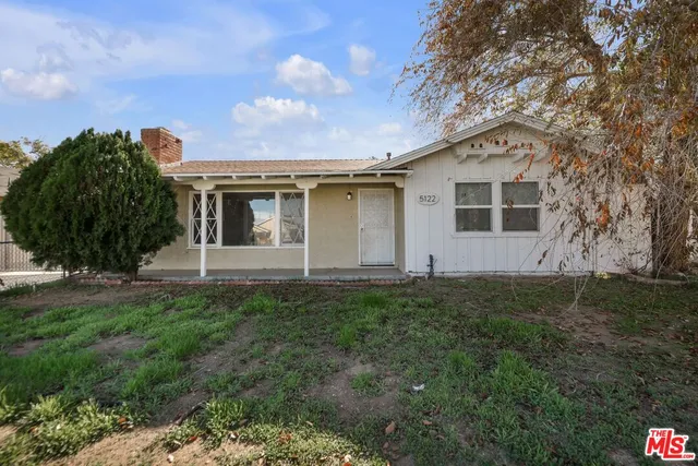 a front view of house with yard and trees