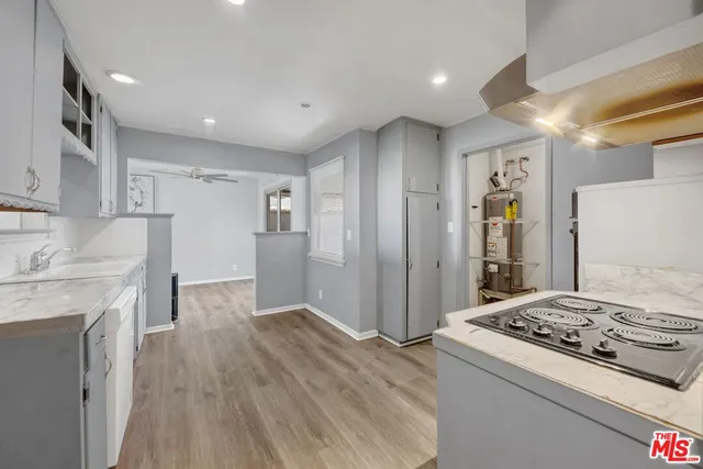 a kitchen with a stove and a refrigerator