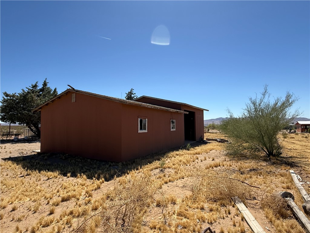 8051 7th Street Dolan Springs, AZ 86441 - Photo 59 of 65 a view of a blue house with a yard