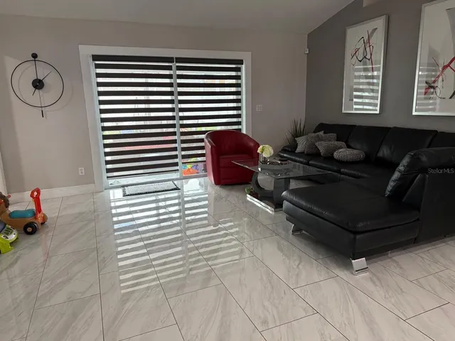 a living room with furniture and a window