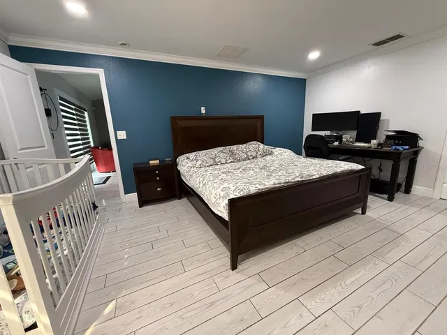 a bedroom with a bed and a television