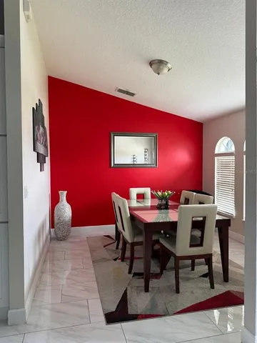a dining room with furniture and window