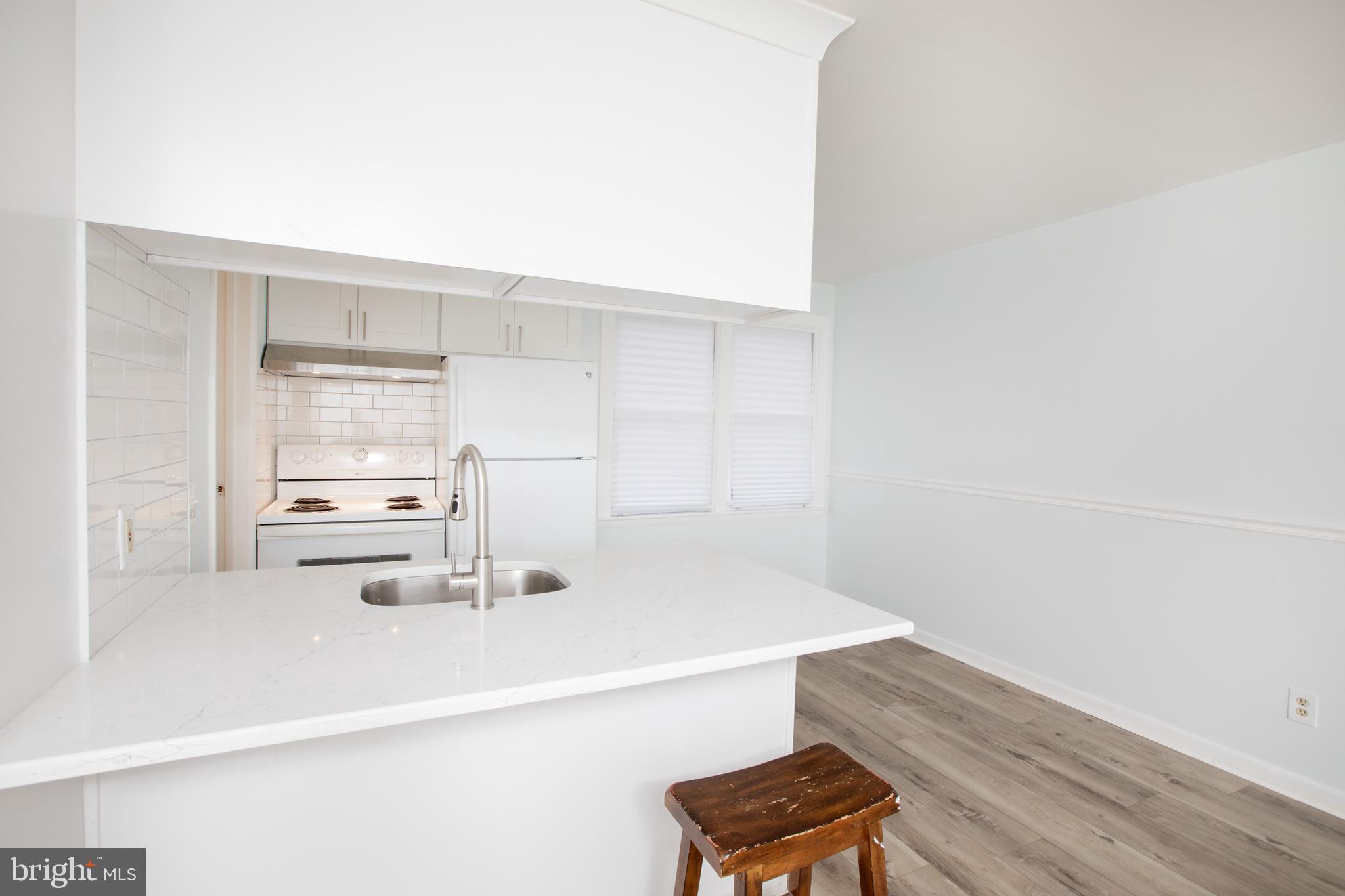 129 South Main Street, Unit A New Hope, PA 18938 - Photo 3 of 8 a kitchen with a sink cabinets and wooden floor